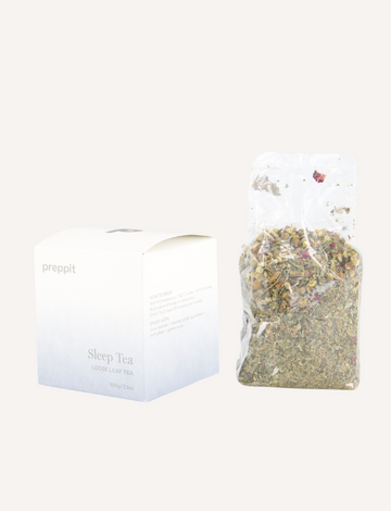 A box marked "Preppit Sleep Tea" alongside an open transparent bag reveals a calming blend with chamomile and lemon balm. The white box features a light blue gradient, complementing the serene tea mix in the visible bag.