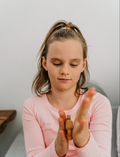 A young girl focuses with a Sensory Play Australia Wooden Fidget, providing calming tactile input for emotional regulation.