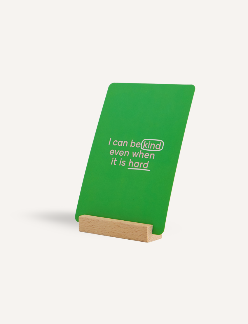 The Play Way Regulation Card Set Bundle features a therapist-designed green affirmation card in a wooden stand. It promotes emotional growth for children.