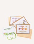 Contents of Mrs Green Pocket Press: pressed flowers, wooden boards, and instructions for crafting.