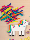 Pony Pile-Up Balancing Game pieces and unicorn figure on a wooden surface.