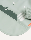 Sage green baby bib with green crocodile graphic and elasticated cuff. 100% friendly label.