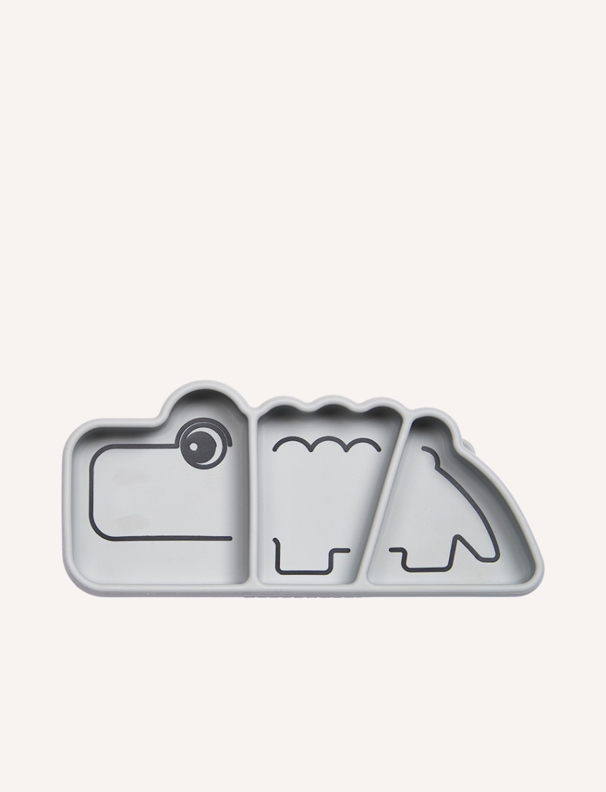 Grey silicone plate shaped like a crocodile with three divided sections and black line drawings of features.