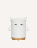 White ceramic owl ultrasonic essential oil diffuser with wood base.