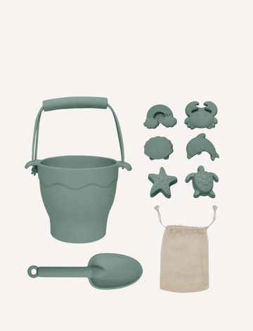 The Playground 8-Piece Bucket & Spade Set features a BPA-free silicone brown bucket, spade, five animal molds (cloud, rainbow, crab, shell, turtle), and a starfish mold. A white drawstring bag is included for easy storage—perfect for sandcastle crafting!.