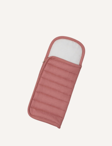 A pink quilted sleeping bag, open to show a white inner lining, on a plain background.