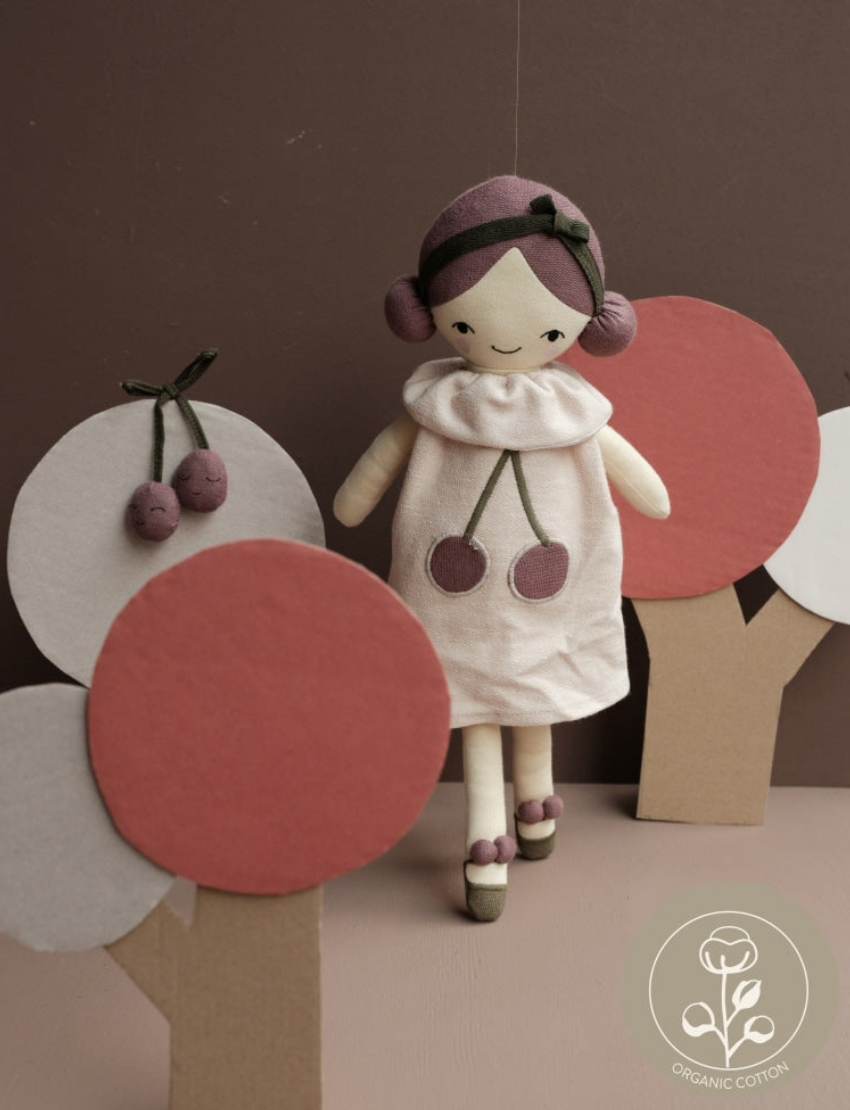 Plush doll 'Cherry Pie' with cherry motifs and cutout trees in background