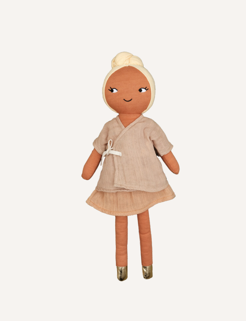 Plush doll 'Simran' with tan skin, blonde hair bun, and neutral kimono dress