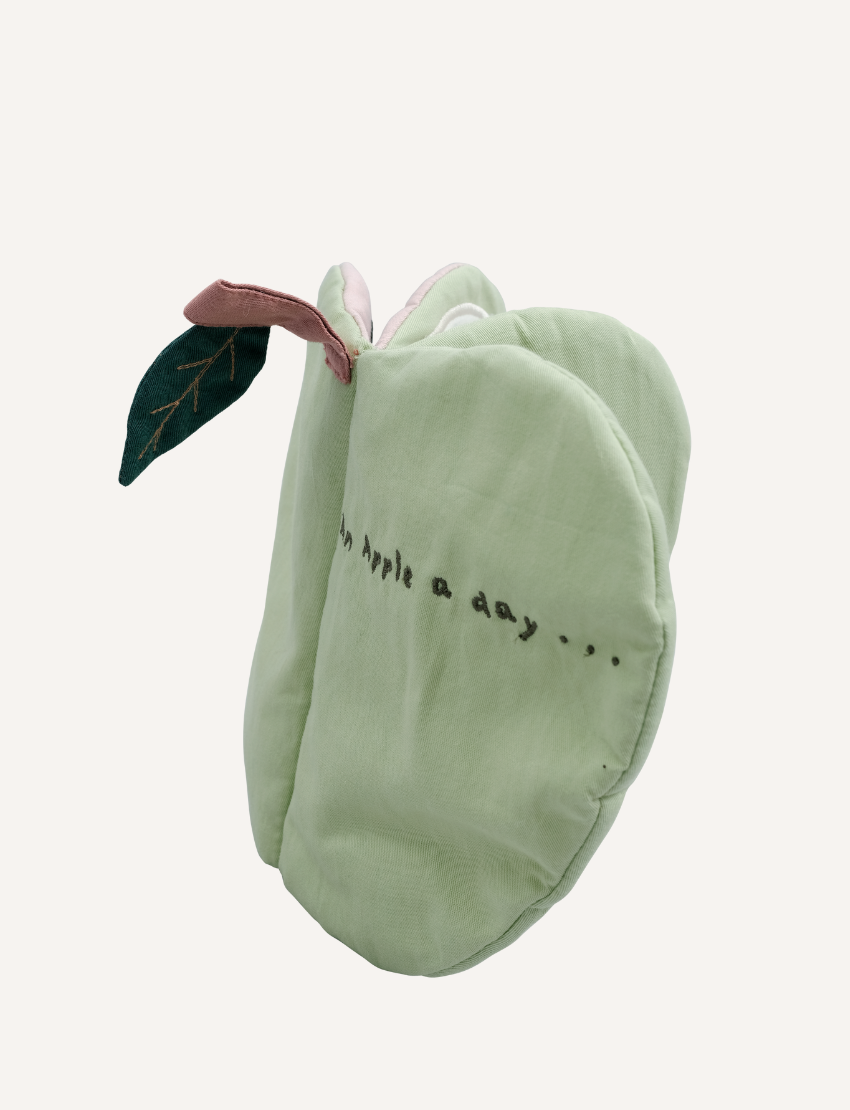 Green fabric apple book closed, with a leaf detail and embroidered text 'an apple a day...'