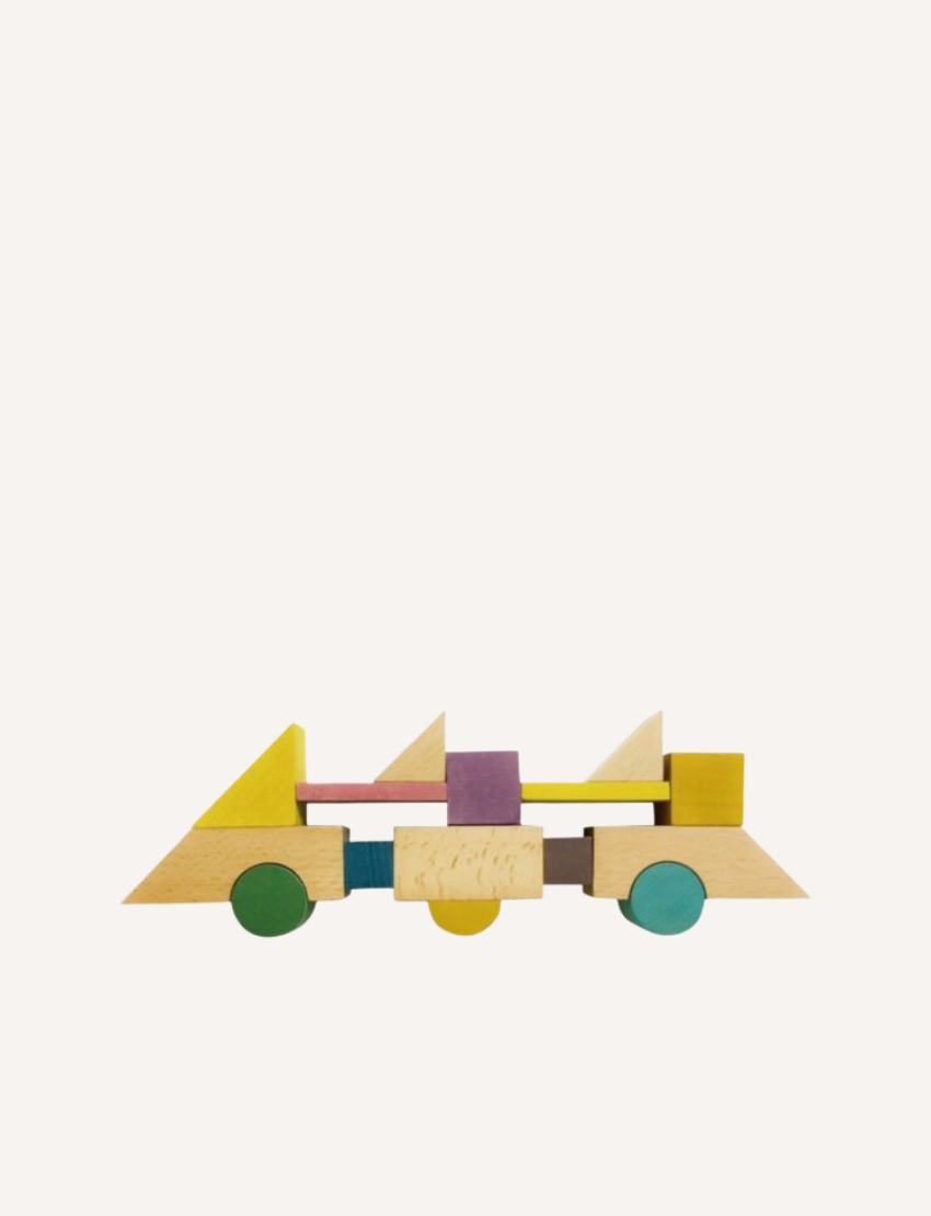 Tsumiki House of Blocks set assembled into a detailed wooden house with a pull toy, offering imaginative play.