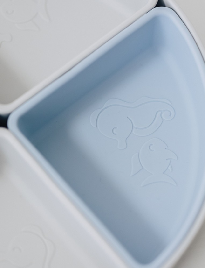 Close-up of Misty Sky Silicone Divided Plate sections with whale & dolphin embossing.