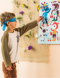 A boy with a blue blindfold on attempts to pin a fabric tail onto a character in a