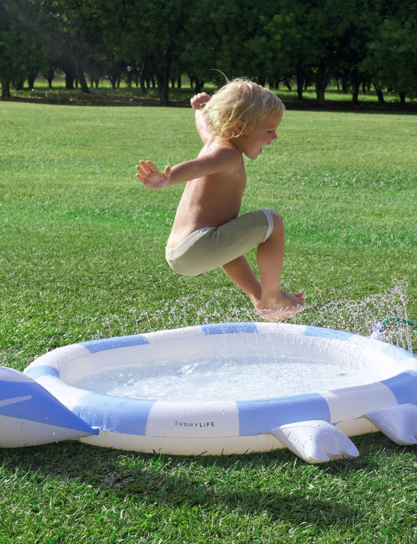 An inflatable turtle sprinkler mat with blue and white stripes, designed for outdoor play.
