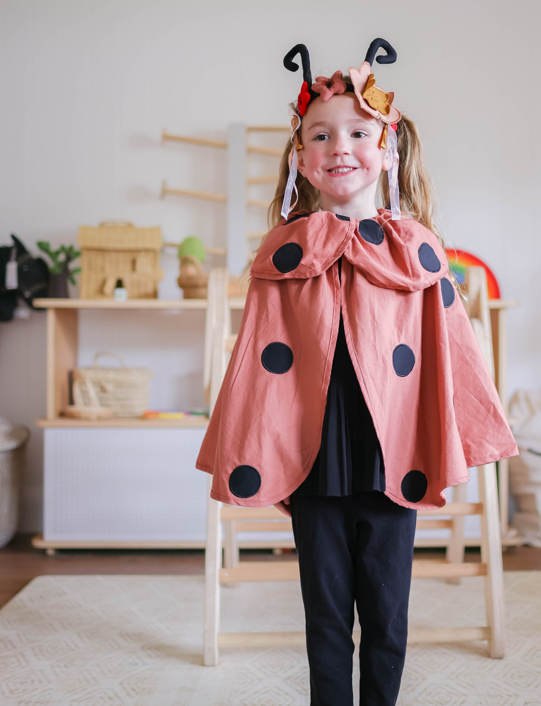 Ladybug dress-up costume with polka dot wings and floral headband with antennae.