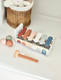 Speedy Monkey xylophone and ball toy set with colorful balls and xylophone bars on a white shelf.