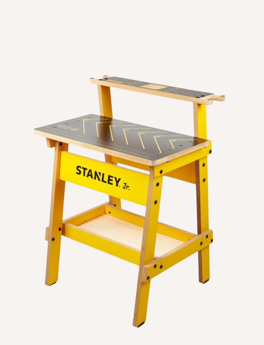 Yellow Stanley Jr. kids' workbench with tool slots, rulers, and sturdy wooden construction.