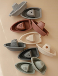 Colorful collection of rubber bath boats for toddler water play and bath time fun.