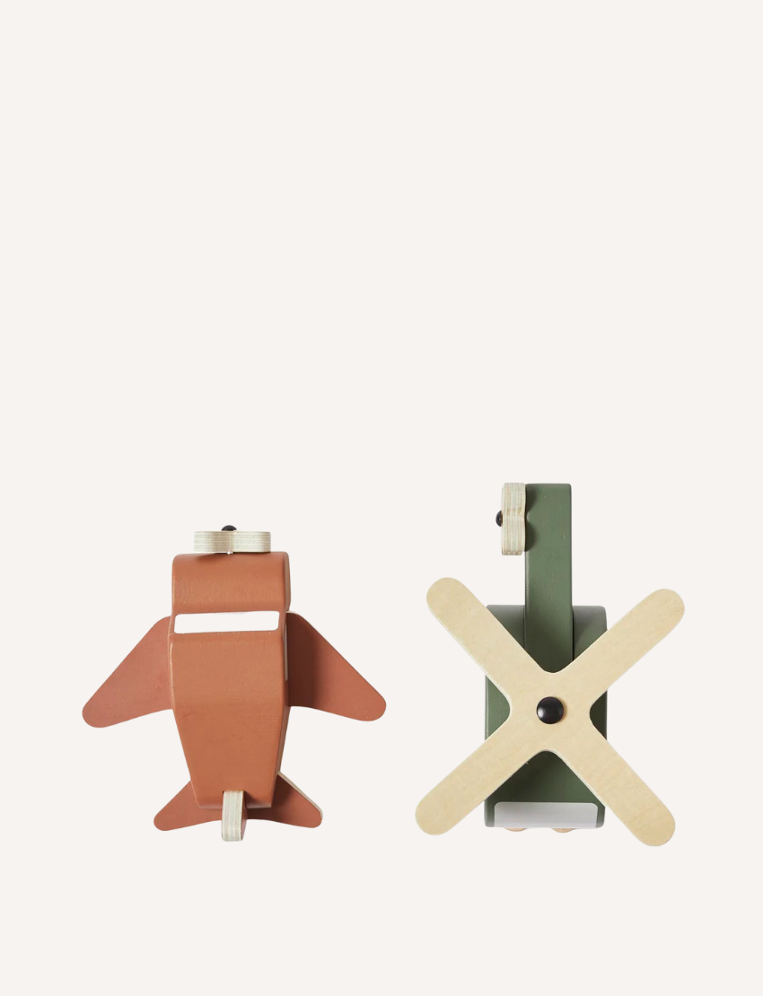 Back view of a brown airplane toy and a green helicopter toy made of wood.