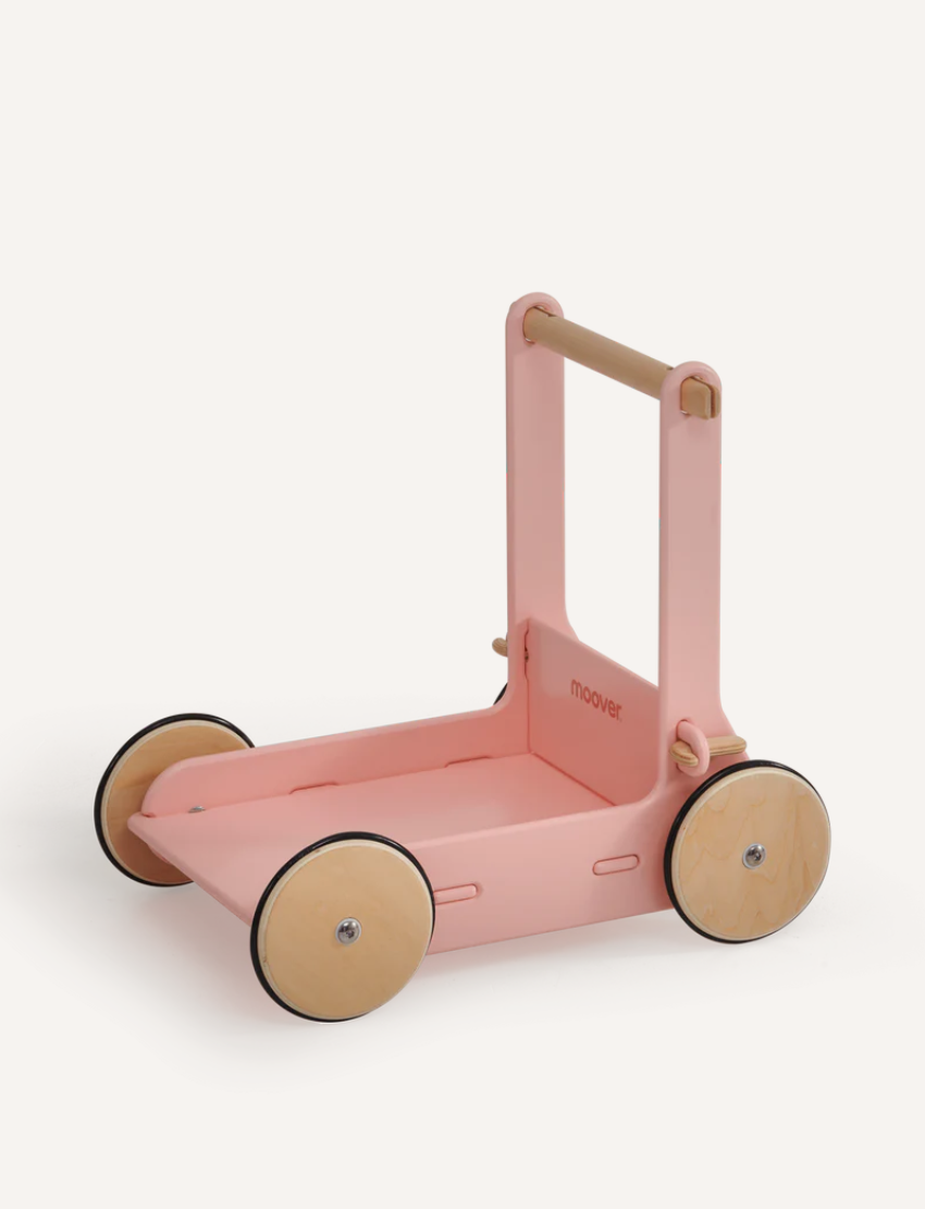 Sage green Moover classic baby walker from a high angle, showing a baby reaching for it.