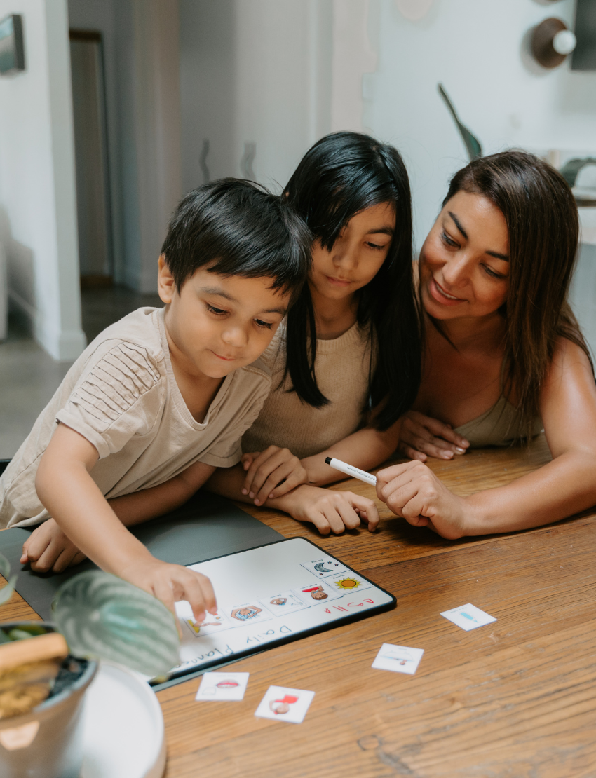 Child using the Sensory Play Australia Kinder Routine Magnet Set to plan their day with visual cards, a therapist-designed tool.