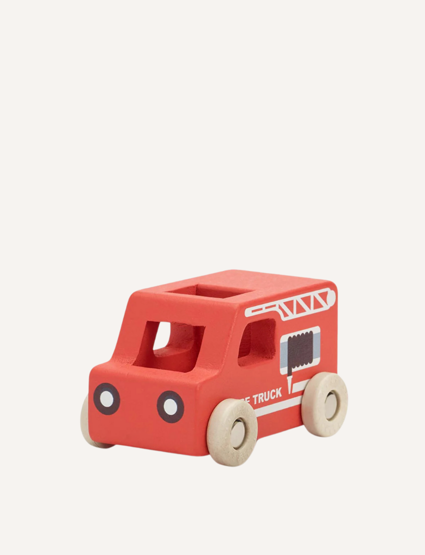 Wooden toy ambulance with red accents and a white cross, on a light background.