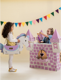 Two children playing with cardboard costumes: one a unicorn, the other a castle, fostering creative storytelling.