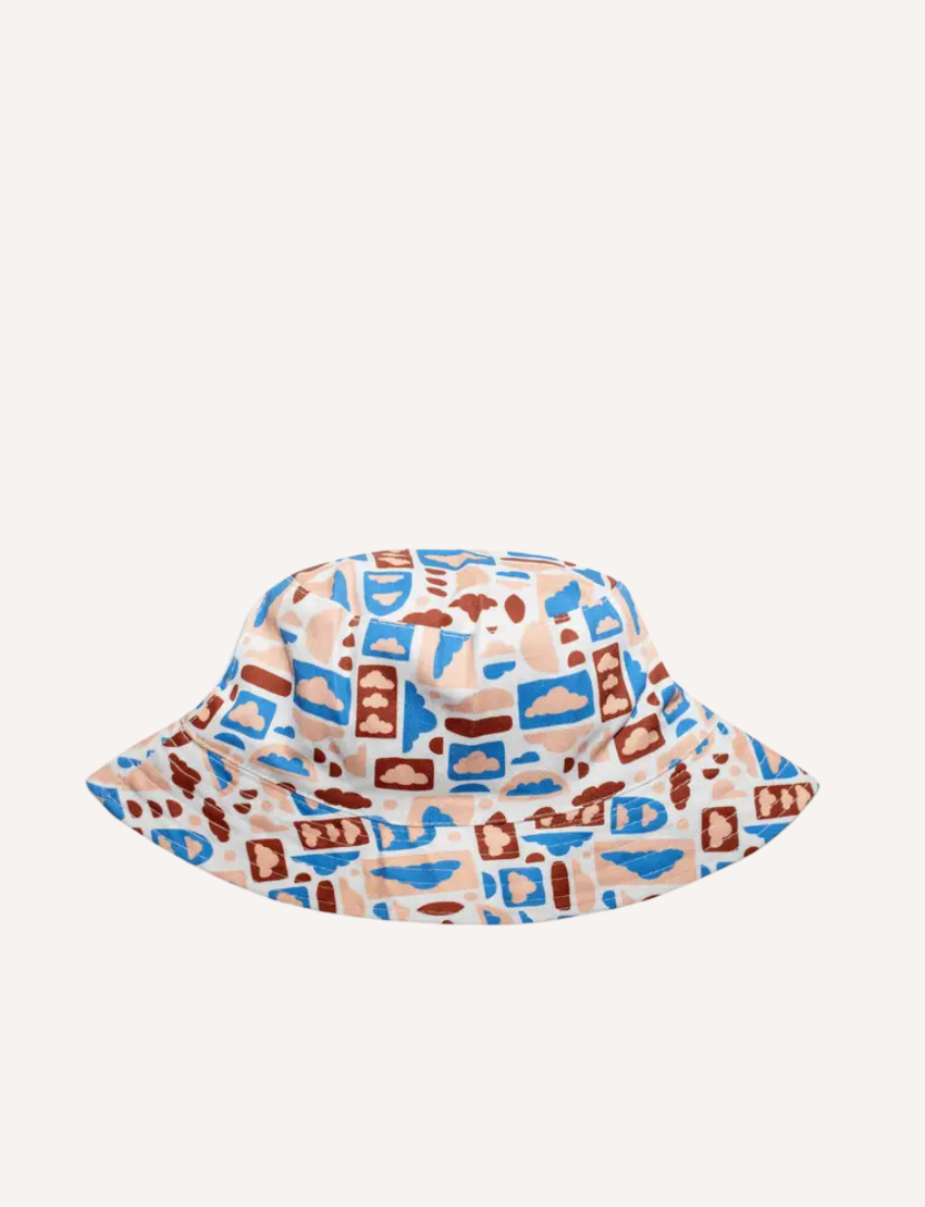 White bucket hat with a fun, abstract pattern of clouds and shapes.