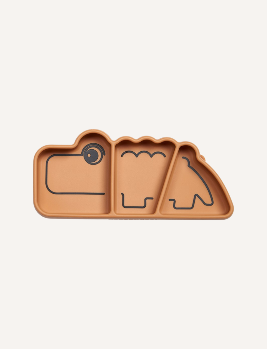 A light brown silicone snack plate shaped like a dinosaur, designed for children's snacks and mealtime.