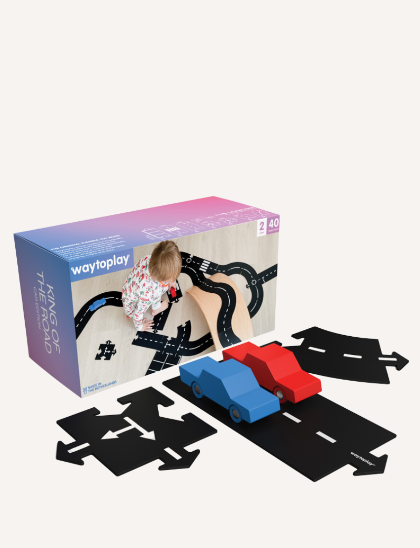 Way to Play 'King of the Road' toy race track with cars and a child playing. Flexible road construction toy for endless play.