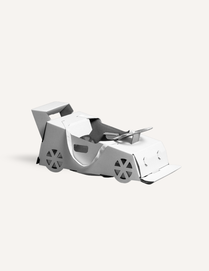 White cardboard 3D race car model with spoiler and black wheels.