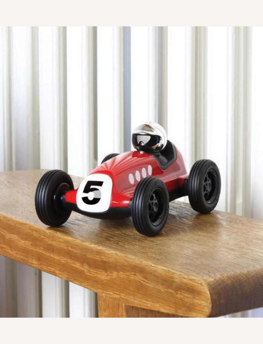 Red vintage toy race car with number 5, black wheels, and a driver in a helmet.