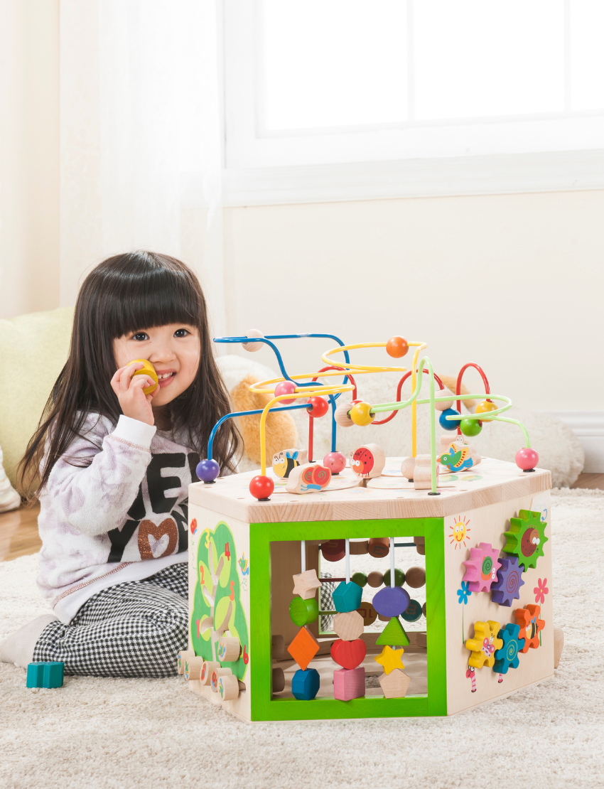 Wooden multi-activity cube with bead maze, xylophone, gears, and shape sorter.