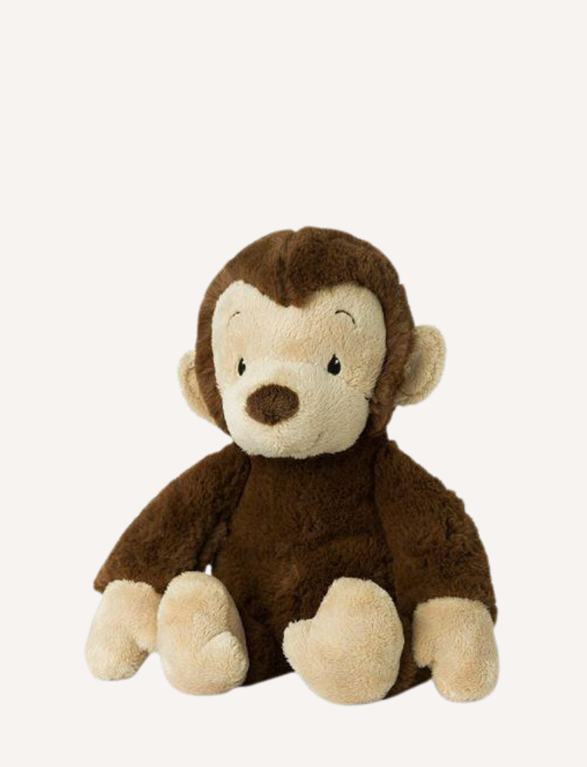 Plush brown monkey with light beige face and hands sitting on a white background.