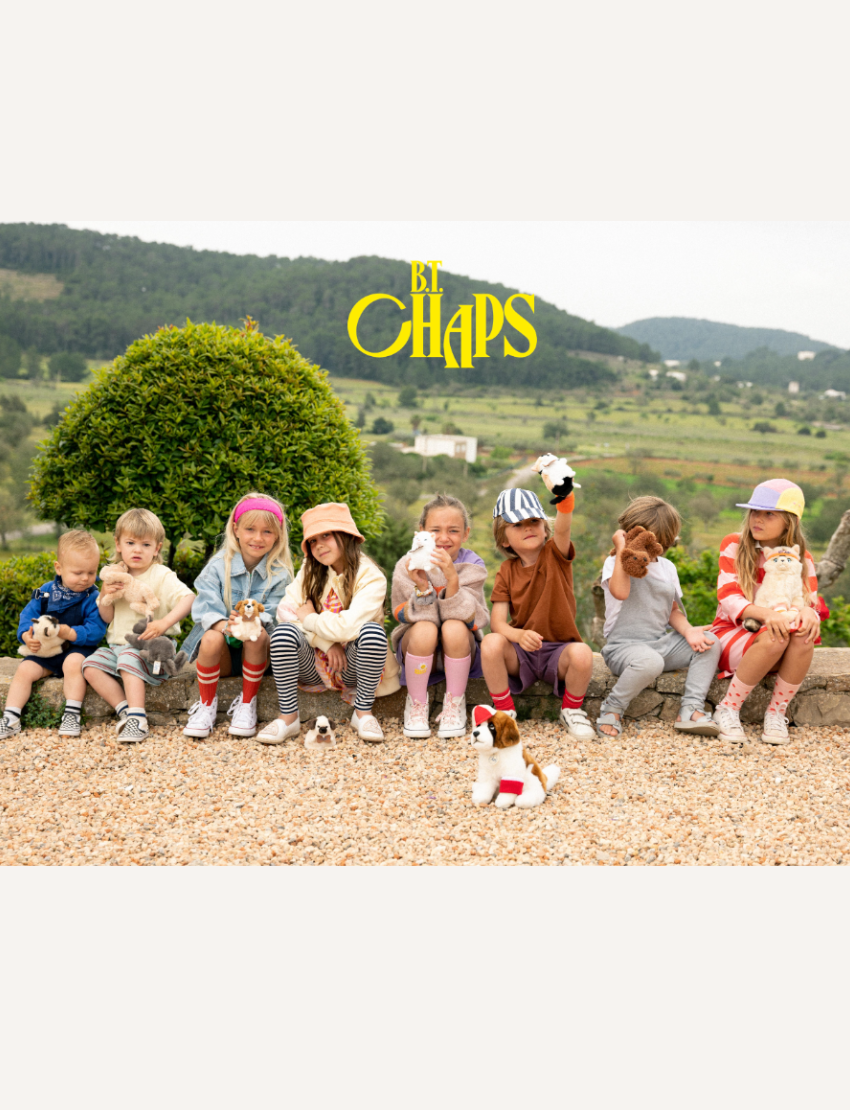 Group of children with Chaps Mail plush toys sitting on a wall, showcasing fun and playful fashion.