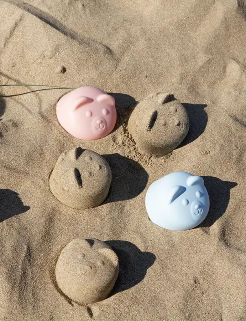 Close-up of a baby wearing stylish blue bear-shaped sunglasses with reflective lenses.