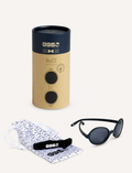 Ki Et La RoZZ black kids' round sunglasses, shown with their stylish navy & brown packaging tube and a convenient carry pouch.