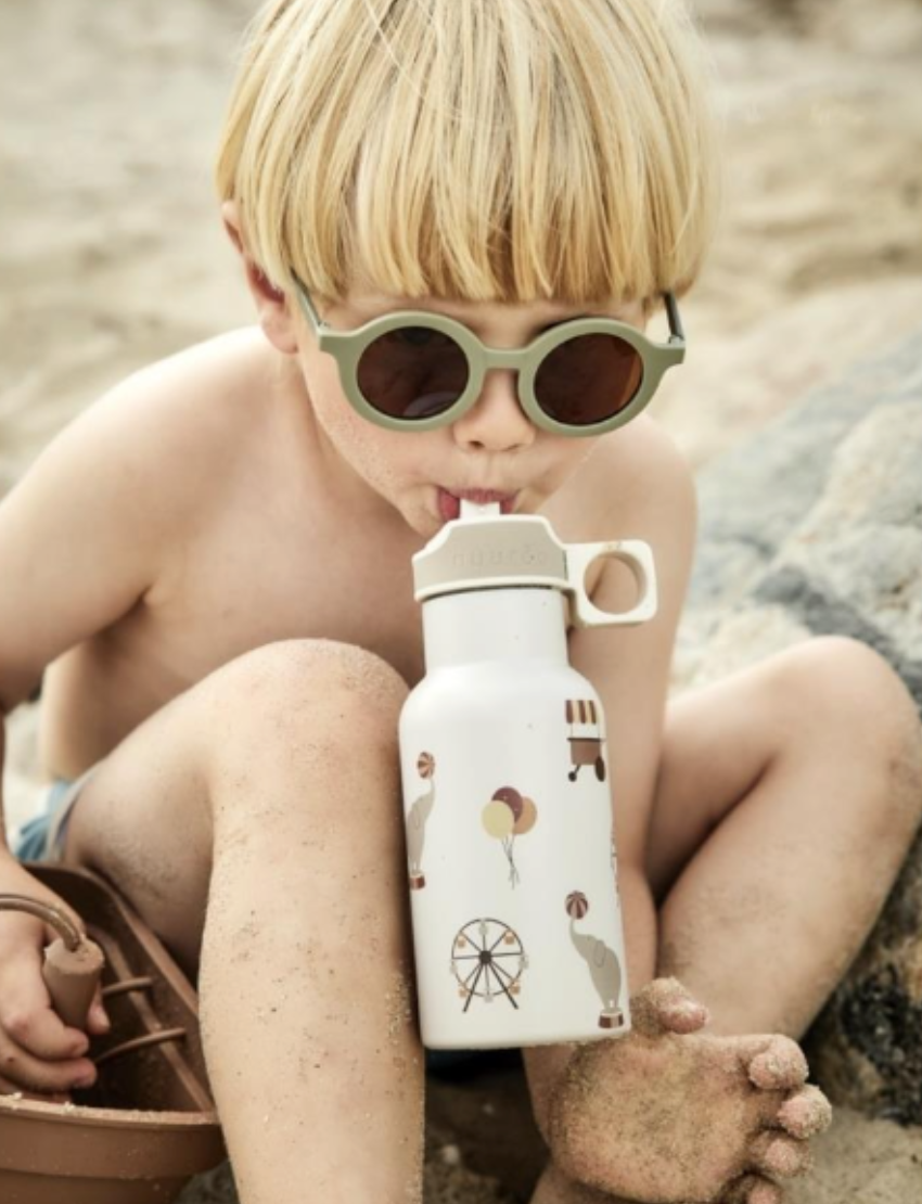 Single pair of sage green round kids' sunglasses with brown lenses, viewed from an angle, offering stylish eye protection.