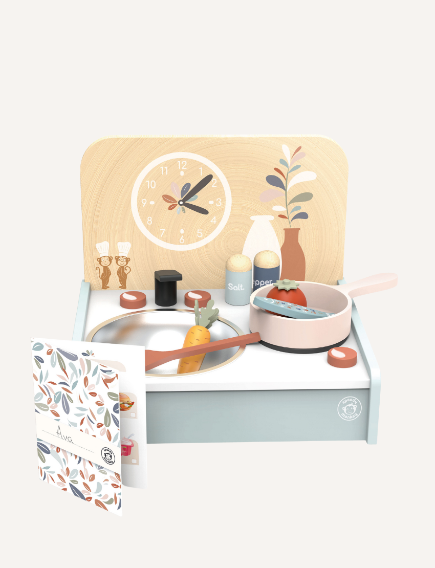 Speedy Monkey wooden table kitchen playset with accessories including pots, pans, food, and clock, promoting imaginative play.