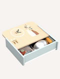 Open Speedy Monkey wooden table kitchen drawer revealing cookware and food items, neatly stored for organized play.