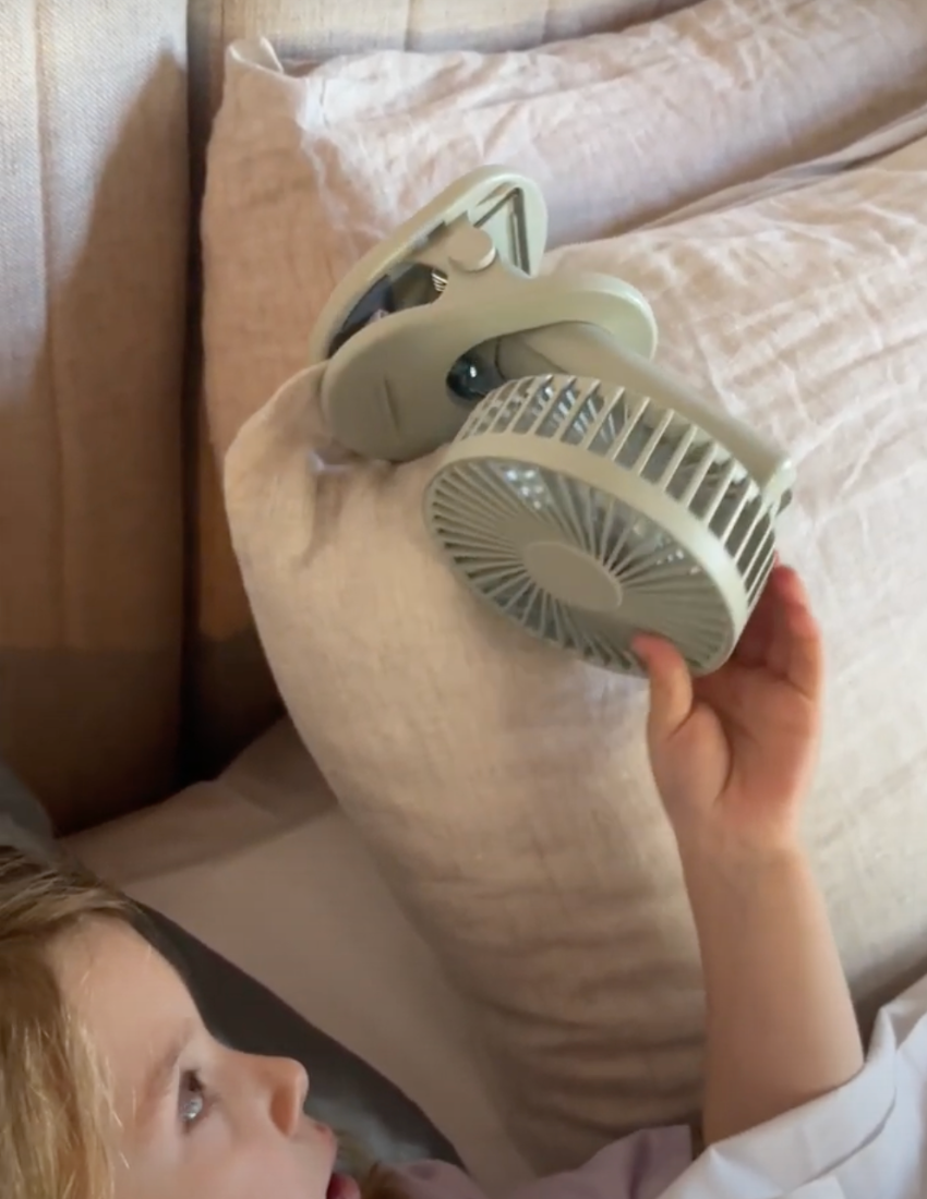 The Play Way Sleep Fan: Grey portable clip-on fan with rechargeable battery, ideal for soothing white noise and restful sleep.