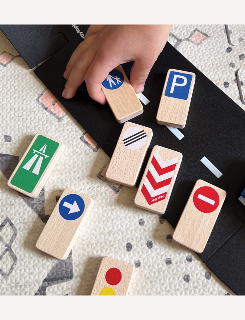Wooden toy traffic signs: pedestrian crossing, turn right arrow, and traffic light.