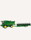 Green John Deere combine harvester towing a detachable green header on a trailer.