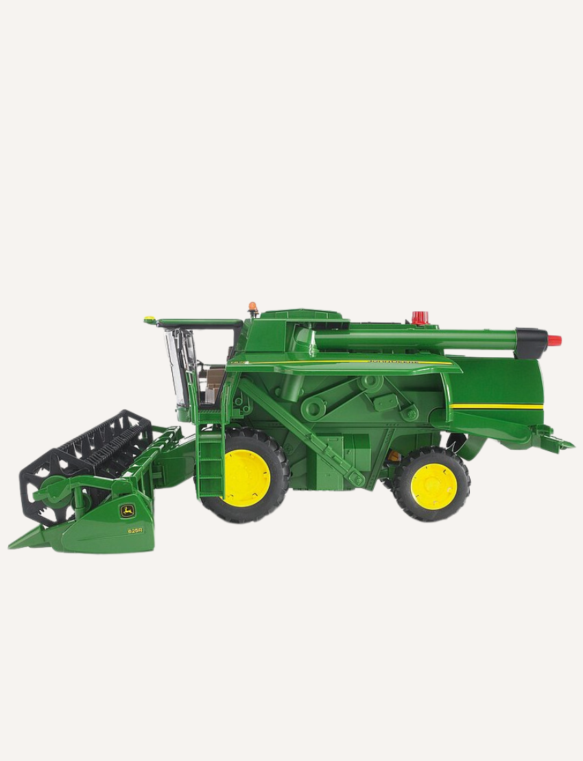 Green John Deere combine harvester with its header attached, ready for use.