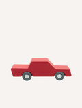 Red wooden toy car with grey wheels on a plain background.