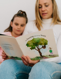 Mother and daughter reading 'The Buzzing Bees in My Brain' by The Play Way, a therapist-designed book supporting emotional well-being.