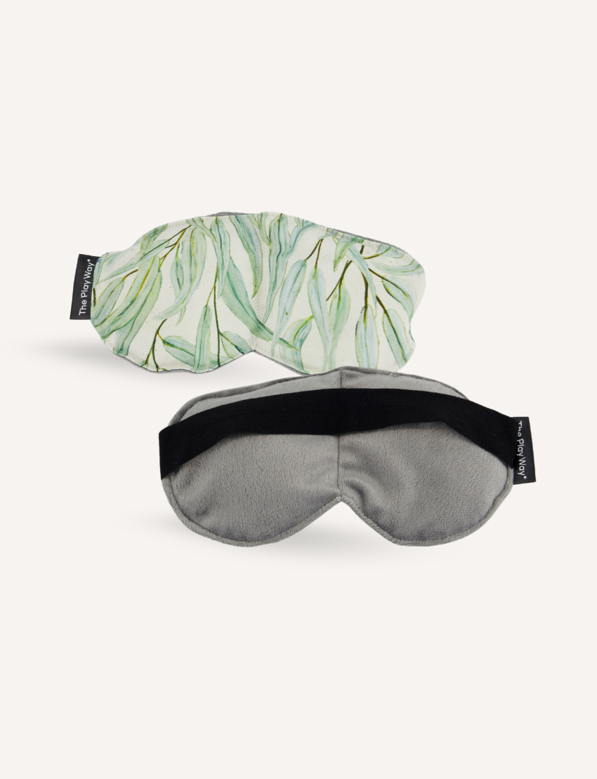 The Play Way's Regulation and Reflection Kit includes a calming weighted eye mask with leaf print and a soft grey mask, aiding relaxation and sleep.