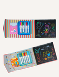 Open sketchbooks with chalk markers and colorful drawings of fairies and construction vehicles.