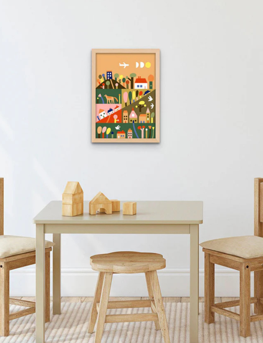Children's room setting with a colorful 'Townscape' paint by numbers artwork framed on the wall.