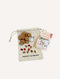 Poppy & Daisy DIY Tic-Tac-Toe kit with drawstring bag, wooden slices, charms, paint, and instructions.