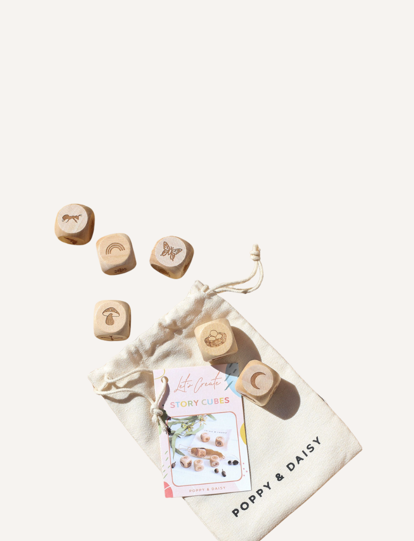 Poppy & Daisy nature story cubes scattered around a drawstring bag and activity card.